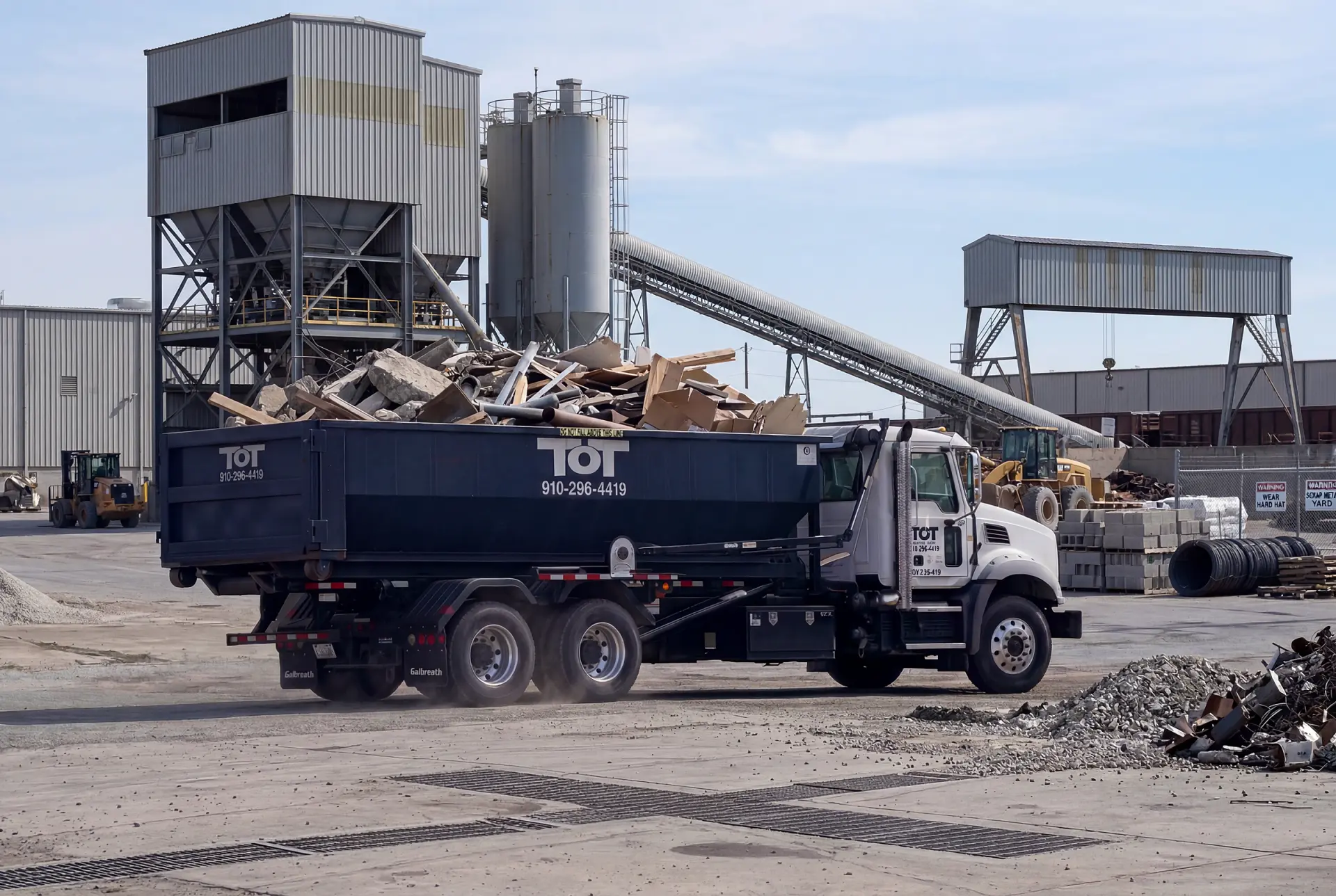 Aerial view of Tons of Trash roll-off dumpster truck delivering a container in rural eastern North Carolina