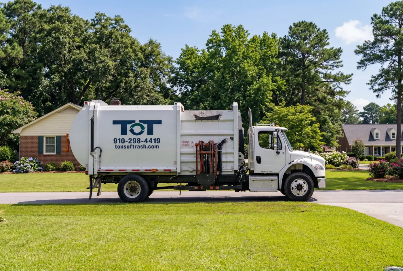Tons of Trash branded side loader truck on a residential street in eastern North Carolina
