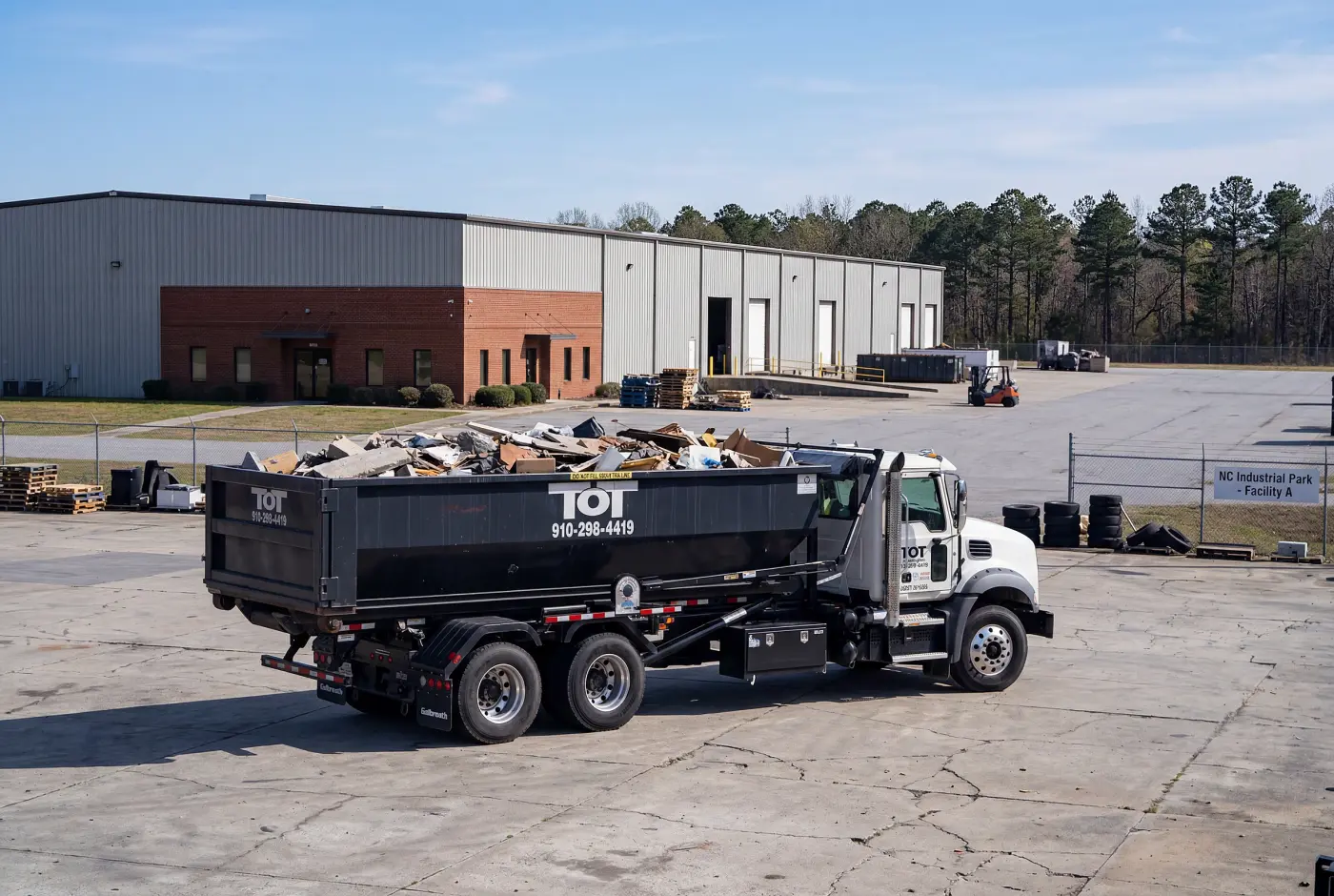 Aerial view of a Tons of Trash roll-off dumpster on a construction site